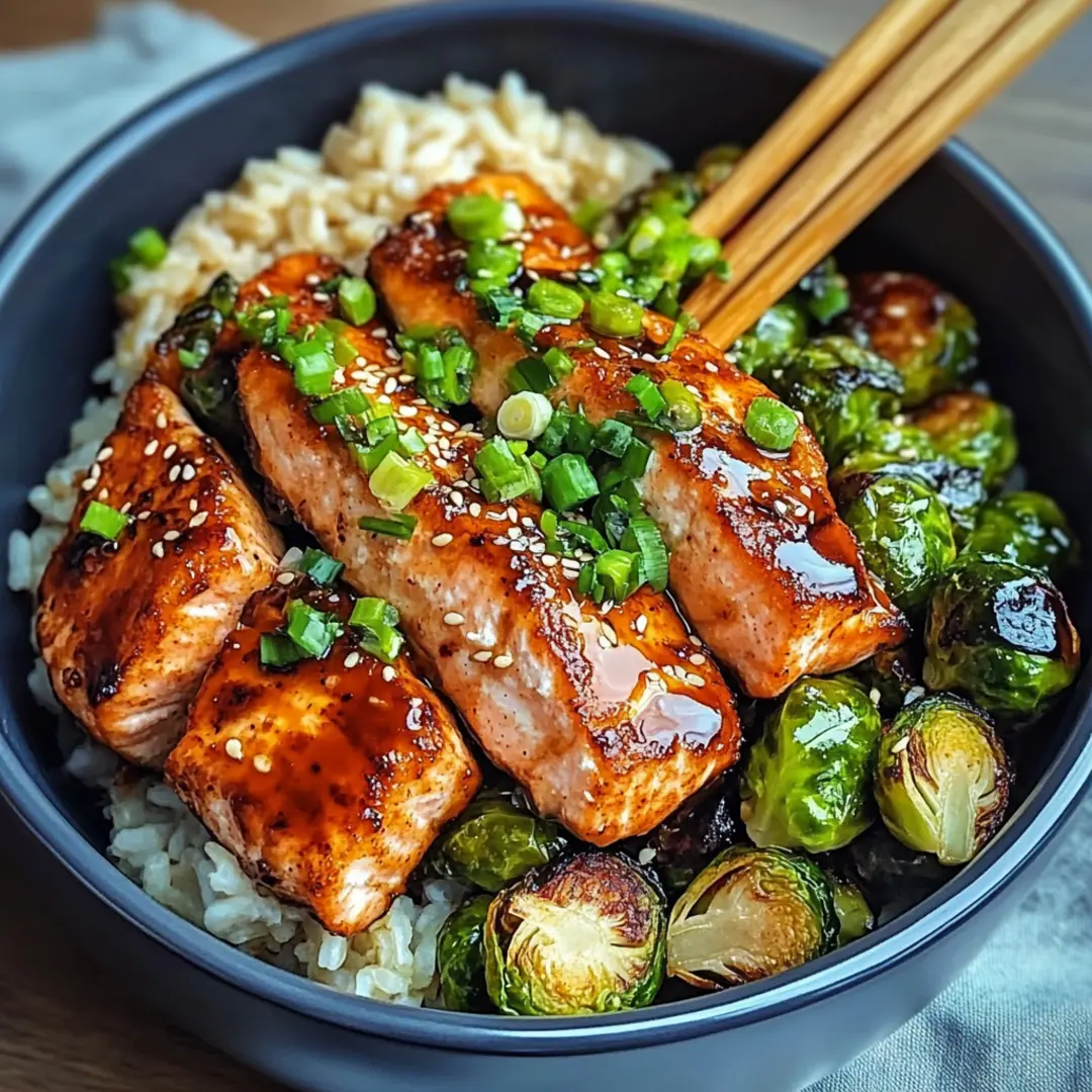 Teriyaki Salmon Bowls with Crispy Brussels Sprouts1 Close-up of a vibrant teriyaki salmon bowl with roasted Brussels sprouts and rice.